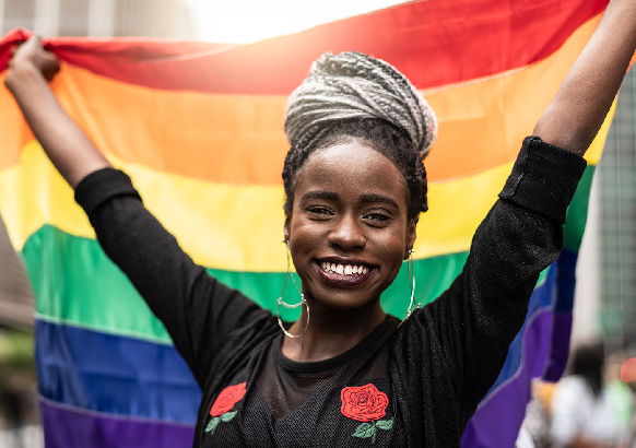 Woman holding pride flag Woman holding pride flag